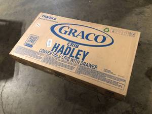 lot 19 image: Graco Hadley 4-in-1 Black Convertible Crib with Drawer  Customer Returns See Pictures