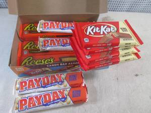 lot 284 image: (B-1) Box of 12 King Size Candy Bars 4 Each of Kit Kat, Pay Day and Reeses Peanut Butter Cups Best by Date Vary March - Aug 2024