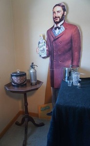 lot 1 image: Vintage Advertising Dr. McGillicuddys Schnapps Life-Size Cardboard Statue, Hand-Carved Octagon Occasional Table...