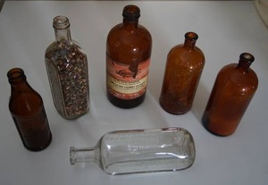 lot 22 image: Collectible Vintage Brown Clear Advertising Bottles...