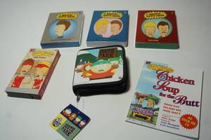 lot 104 image: Collectible Beavis and  Butt-Head Volume 1-2-3 DVD Series(Volume 2 unopened) Work Sucks VHS, Chicken Soup for the Butt Book and South Park DVD Case