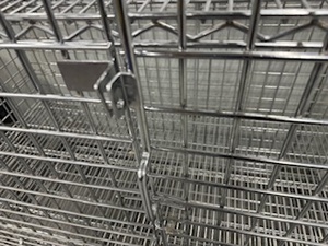 lot 103 image: Mobile Uline Safety Cage with Locking Wheels