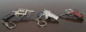 lot 204 image: 3 Vintage Pistol Cigarette Lighter Keychains