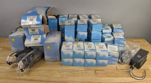 lot 63 image: Assortment of Miscellaneous Electric Supplies Wrist Watch Panic Remote, Lamp Module, Wall Switch Module, Decorator Style Wall Switch, Pan & Tilt Kit with Camera, Motion Sensor with Flood Lights, Screw-In Lamp Module, Lola Remote Music System, Etc. H
