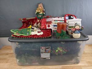 lot 151 image: Assortment of Christmas Dcor, Wreaths, Premium 7.5 Ft. Rolling Christmas Tree Bag, Candle, Cheerful Snowman, Baking Dishes, Cloth Advent Calendar, Etc. H
