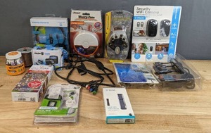 lot 184 image: Fitbit Band Accessory, Wii Remote Pulse Pak, Beat Sync Sound Activated Lights, Compression Connectors, Dash Cam, Wireless Headset, Monster Cable, Lifesaver Photoelectric Sensor, Security Wi-Fi Camera, Etc. H