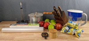 lot 208 image: PUR Pitcher, Butcher Block with Knifes, Dcor Fruit, Stovetop Popcorn Popper, Wooden Salt Box, Iron Trivet, Paper Towel Holder, Etc. H