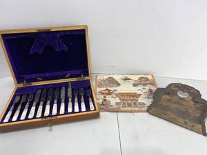lot 197 image: WOOD BOX FLATWARE MOTHER OF PEARL HANDLES, BRASS CRUMB CATCHER AND CLOTH WALL HANGING
