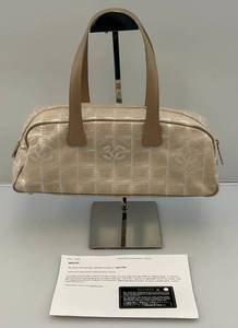 lot 1 image: EST $600-$800  2003-2004 Beige CHANEL Travel Line Boston Handbag 34, Gold Hardware, Numbers Matching Chanel Card &Purse Tag (8601639) (VERY NICE CONDITION)