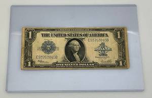 lot 16 image: 1923 E Large One Dollar Silver Certificate Blue Seal  (In Protective Holder)