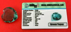 lot 22 image: 54.80 CTS Heart Shaped Green Topaz With Card