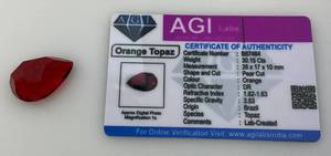 lot 26 image: AGI Labs 30.15 Cts Pear Cut Orange Topaz With COA