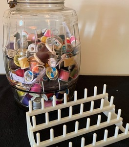 lot 76 image: Glass Jar with Thread Spools and a Thread Holder