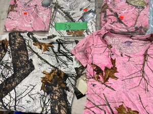TABLE FULL OF WOMENS CAMO SHIRTS