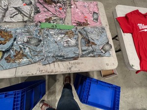 TABLE FULL OF WOMENS CAMO SHIRTS