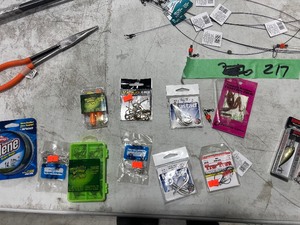 TABLE FULL OF CATFISH LURES, LINE, HOOKS, & ROD