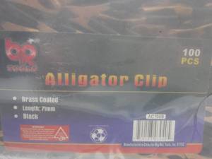 lot 4 image: Brass Coated Alligator Clips  Approximately 100 Pieces In Container 