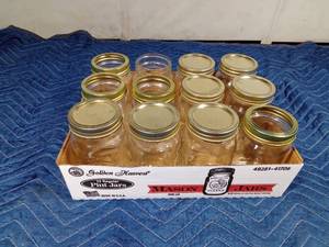 lot 74 image: Case of pint size Mason canning jars with some lids