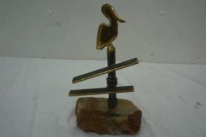 Brass pelican figurine on quartzrock base