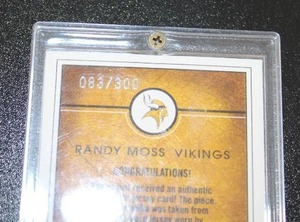 lot 115 image: 2003 Fleer Avant Work of Heart Randy Moss Jersey Relic #WHRM 83300  Only 300 Exist