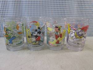 lot 93 image: (BS) 4 McDonalds Walt Disney 100 Years of Magic Glasses Goofy, Mickey, Pinocchio and Buzz Lightyear