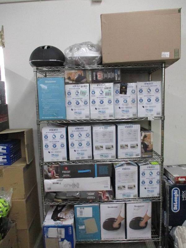 lot 714 image: Rack full of Homedics, Vaporizers, Massagers, Purifiers and More - These items all have some issues or make noise - For PartsRestore