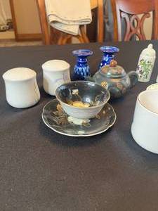 lot 229 image: Thomas Kinkade Coffee Mug, Royal Albert Tea Cup and Saucer, Unbranded Tea Cup and Saucer, Japanese Tea Pot, Salt and Pepper Shakers - 2 Sets, Blue Candle Stick Holders