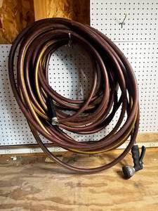 lot 103 image: Maroon Hose with Spray Nozzle