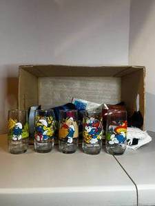 lot 263 image: Box with 5 Smurf Glasses  Towels  Small Makeup Bag  Dog Toys