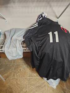 lot 320 image: Lot of Mens Belts, 5 Soccer Jersies SZ M, 2 Pairs of Athletic Pants SZ LG