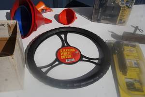 lot 24 image: Automobile Accessory Lot , Steering Wheel Cover, Hitch, Ball Hitch, Inflation Kit, Syphoning Kit, Fluid Transfer Kit Etc