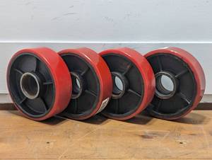 lot 27 image: Set of 4 Cast Iorn wRubber Cover Wheels - 6 x 2  - 1.75 inner Hub - ITI143180A