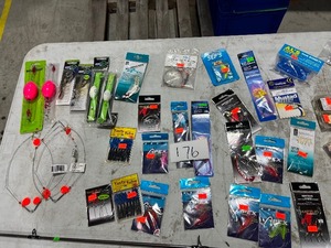 TABLE FULL OF REELS, REEL BUTTER, RIGS, & ROD