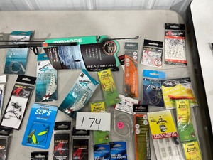 TABLE FULL OF SNELLED HOOKS, RIGS, & FISHING POLL