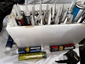 lot 223 image: Bin of Variety of New Caulk and Caulk Gun