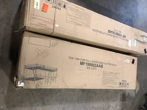 lot 39 image: Twin Over Full Bunk Bed w A Twin Size Loft Bed Attached w A Desk Metal Black    Customer Returns See Pictures