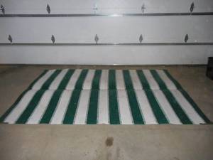 Wicker outdoor chairGreen and white outdoor rug