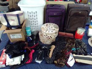 Two rolling suitcases with medical and beauty supplies