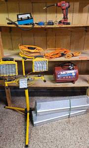 lot 60 image: Garage Accessories includes Double Stand Light, Collapsible Saw Horses, extension cords, rechargeable inflator, battery tester, RPM tester