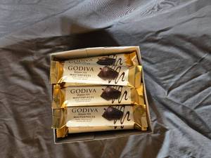 lot 20 image: Godiva dark chocolate and ganache filled candy bar Box of 24 bars Best By April 2024