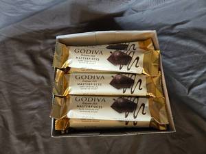 lot 23 image: Godiva dark chocolate and ganache filled candy bar Box of 24 bars Best By April 2024