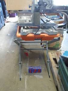Rigid tile saw on stand with tub & pump. As shown.