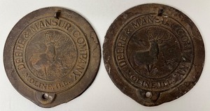 lot 254 image: Pair of DEERE & MANSUR Company Cast Iron Corn Planter Covers