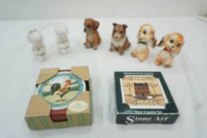 lot 81 image: Little Boy & Girls Salt & Pepper Shaker, 2 vintage dog noice makers, 2 little dog figures and 2 sets of coasters New