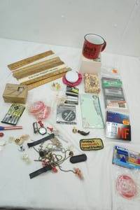 lot 82 image: Pink Ribbon Mug by Avon, variety of advertising rulers, Candle, recording tapes and more