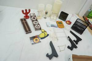 lot 102 image: Home Decor, Plate Holders, vintage cookie stamps, letter holder, plastic candles, ashtray and more