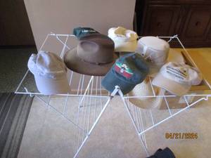 lot 20 image: Coated wire folding rack with assortment of mens hats and caps