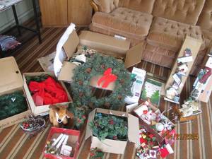 lot 60 image: Large collection of Christmas decor including faux greenery wreaths, lighted garland and animals, plus free standing wood Snowman decor, and vintage ornaments