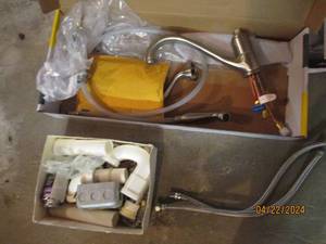 lot 129 image: Kitchen faucet with side sprayer and assorted plumbing pvc and other supplies