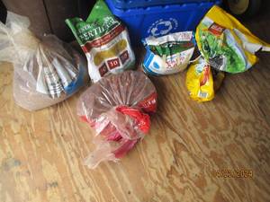 lot 170 image: Misc partial bags of lawn fertilizer and mulch
